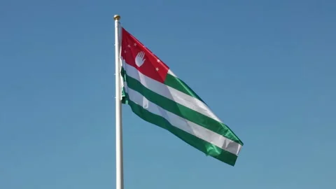 The flag of Abkhazia is developing against the background of a blue sky Stock Footage 158101245