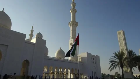 Flag and sunset at Sheikh Zayed Grand Mosque, Abu Dhabi, UAE2 Stock Footage 130701261