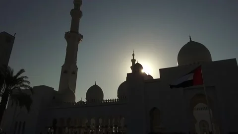 Flag and sunset at Sheikh Zayed Grand Mosque, Abu Dhabi, UAE Stock Footage 130701345