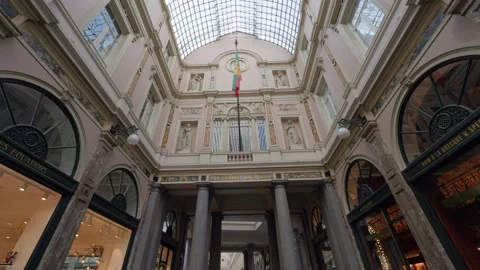 Flag and transparent ceiling in Royal Saint-Hubert Galleries in Brussels Vídeos de archivo 347450639