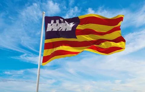 Flag of Balearic Islands , Spain at cloudy sky background on sunset, panorami Stock Illustration