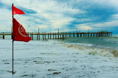 Flag with bathing ban develops in the wind, Atlantic coast beach Stock-Fotos