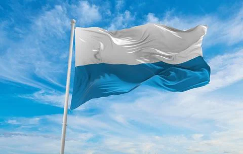 Flag of Bavaria striped at cloudy sky background on sunset, panoramic view. F Stock Illustration