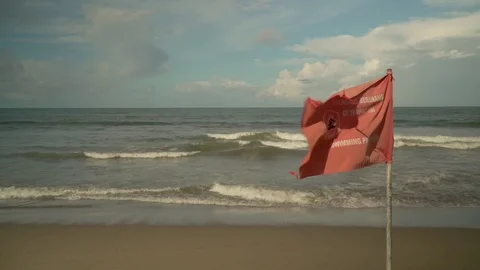 Flag on the beach with the words swimming prohibited Stock Footage 126973880