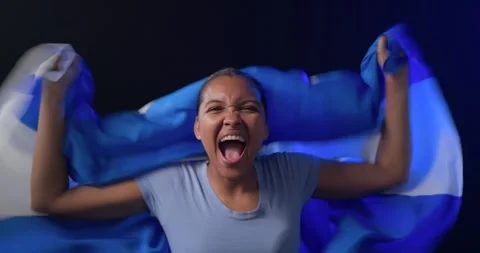 Flag being held up, African American woman stepping out, draping Argentina flag Stock Footage 338436821