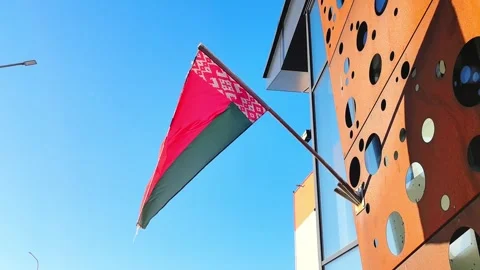 Flag of Belarus waving in the wind near modern building under clear sky on sunny Stock-Footage 328488366