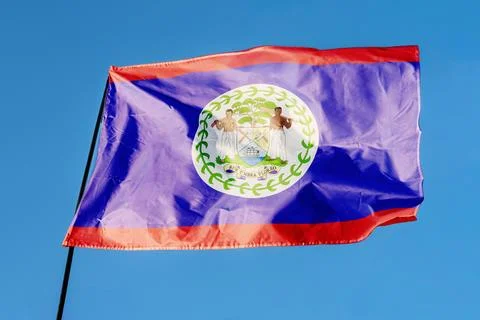 Flag of Belize. Flag waving in the wind against a clear blue sky, fluttering  Foto stock