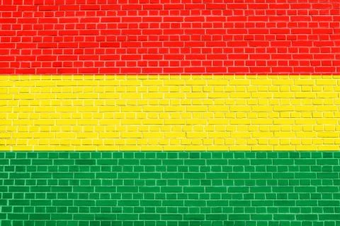 Flag of Bolivia on brick wall texture background Stock Photos