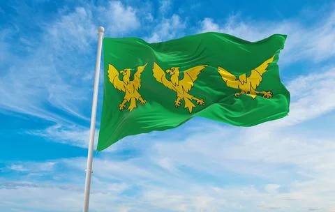 Flag of Caernarfonshire  at cloudy sky background on sunset, panoramic view.  Stock Illustration