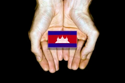 Flag of Cambodia in hands on black background Stock Illustration