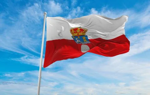 Flag of Cantabria , Spain at cloudy sky background on sunset, panoramic view. Illustrazione stock