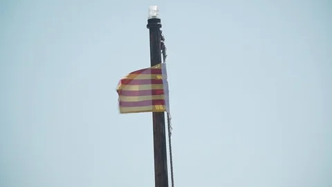 The flag of Catalonia on the mast of the boat develops in the wind Stock Footage 113226527