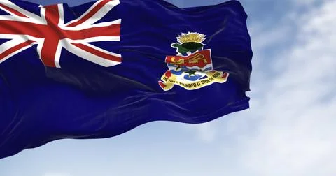 Flag of Cayman Islands waving in the wind on a clear day Stock Illustration