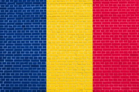 Flag of Chad on brick wall texture background Stock Photos