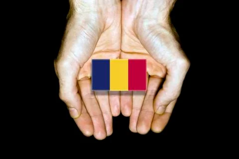 Flag of Chad in hands on black background Stock Photos