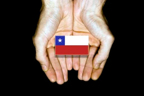 Flag of Chile in hands on black background Stock Photos