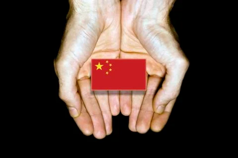 Flag of China in hands on black background Stock Illustration