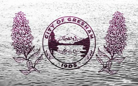 Flag of the city of Gresham, Oregon, USA, on a background of the water surfac 写真素材