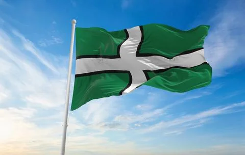 Flag of county Devon , UK at cloudy sky background on sunset, panoramic view. Ilustración de archivo