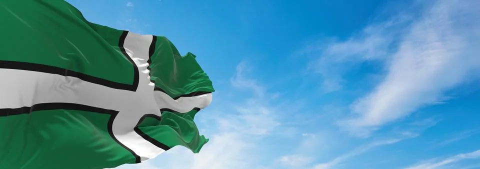 Flag of county Devon, UK at cloudy sky background on sunset, panoramic view.  Stock Illustration