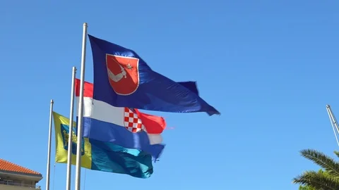 Flag of Croatia Dalmatia region developing in the wind against the blue sky Stock Footage 99190059