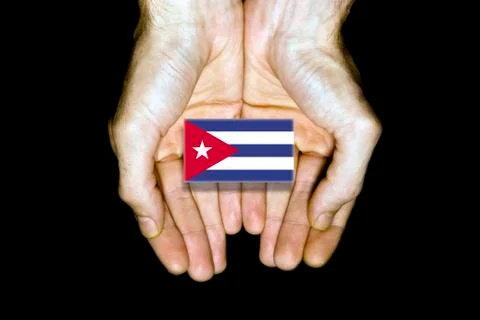 Flag of Cuba in hands on black background Stock Photos