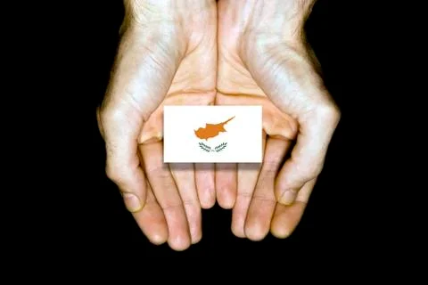 Flag of Cyprus in hands on black background Stock Photos