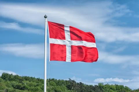 Flag of Denmark with blue sky at the background Stock-Fotos