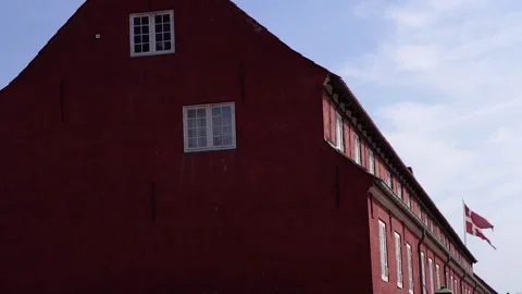 Flag of Denmark. The flag hangs on a red building. Stock Footage 269387201