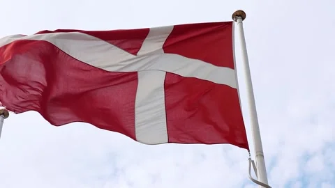 Flag of Denmark flying against a cloudy sky, representing national pride and Stock Footage 345999877