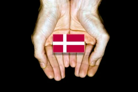Flag of Denmark in hands on black background Stock Photos