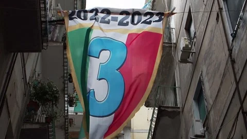 Flag depicting the third scudetto of Naples, displayed in the Spanish quarter Stock Footage 240182508