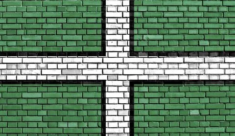 Flag of Devon painted on brick wall 스톡 일러스트