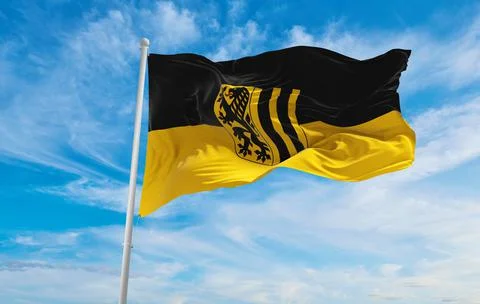 Flag of Dresden at cloudy sky background on sunset, panoramic view. Federal R Stock Illustration