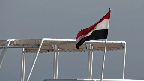 Flag of Egypt flutters in the wind in slow motion. Flagpole is installed on a Stock Footage 304110271