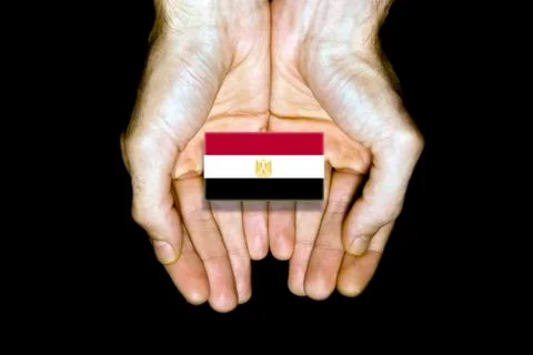 Flag of Egypt in hands on black background Stock Photos