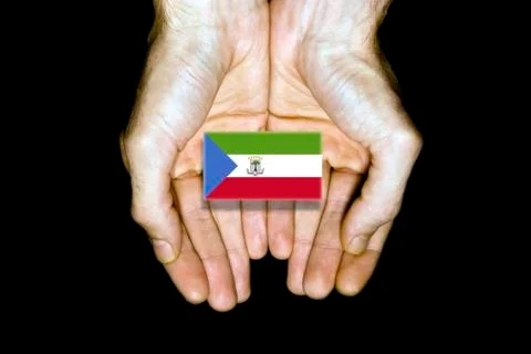 Flag of Equatorial Guinea in hands on black background Stock Illustration