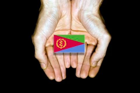 Flag of Eritrea in hands on black background Stock Photos