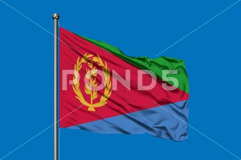 Flag of Eritrea waving in the wind against deep blue sky. Eritrean flag ...