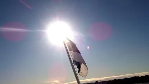 Flag of Estonia and the setting sun Stock Footage 94336941