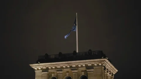 The flag of the European Union is developing at night on the tower of the Stock Footage 108921630