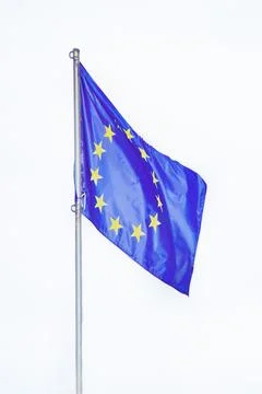 Flag of the European Union, develops in the wind on a flagpole, close-up, iso Stock Photos