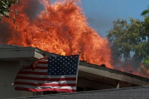 Flag in flames Stock Photos