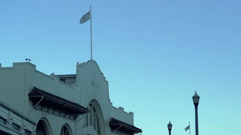 A flag flies over the Pier 26 building along San Francisco bay Stock Footage 95913126