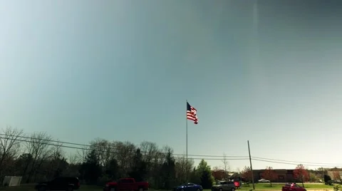 The Flag Flying Above Traffic and Real Life Stock Footage 63080401