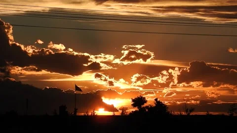 Flag Flying During a Dramatic Golden Sunset 5 Seconds Stock Footage 279856977