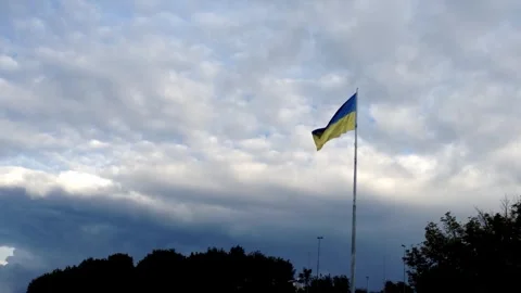 Flag is flying in the sky above a cloudy day Stock Footage 295314205