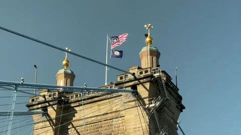 Flag flying a top the Roebling Bridge in Cincinnati Stock Footage 256950762