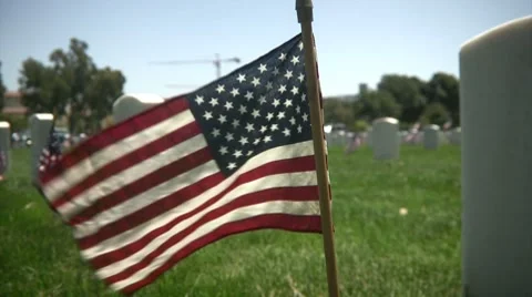 Flag flying at Veteran's Cemetery 스톡 동영상 7736895