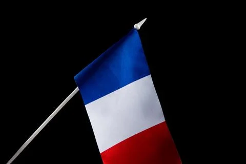 The flag of France on a black background developing flying in the wind Stockfoto's